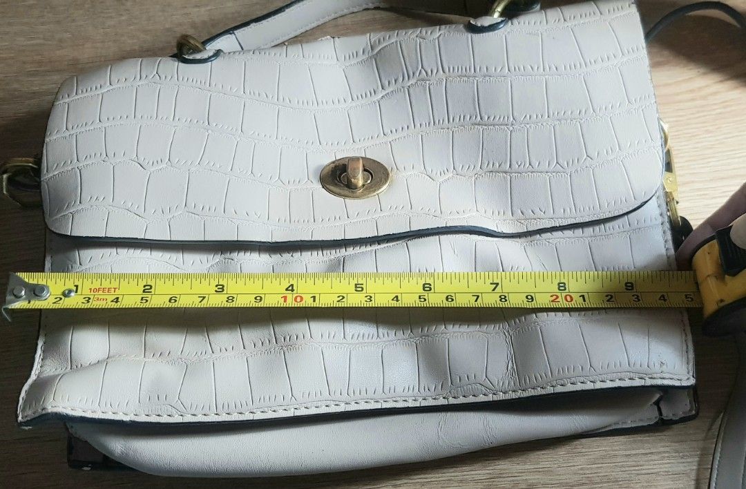 Cream 2 way-bag, small to medium size (Category: Cross-body Bags) located in Quezon City. Submitted by practibagsplusmnl (Listing ID 1389766054, Image 3). Description: Cream 2 way-bag, small to medium size. Soft, crocodile-type leather. 1 exterior pocket, & many pockets, compartments inside, zipper top closure..