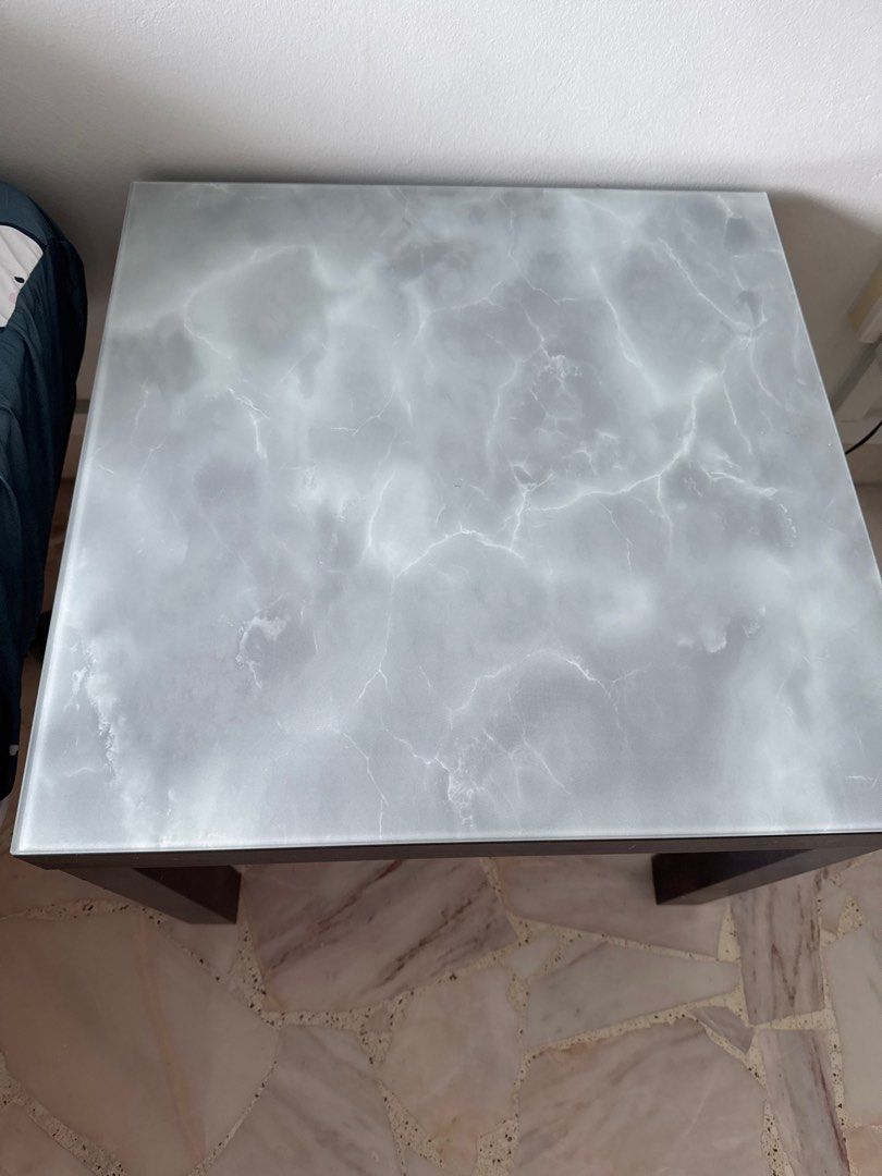 Side Table (Category: Tables & Sets) located in Singapore. Submitted by hero1311 (Listing ID 1389706177, Image 1). Description: - Stylish side table - Marble-look top - Dark wooden legs - Dimensions: 55cmx 55cm and high 46cm. - Ideal for living room or bedroom.
