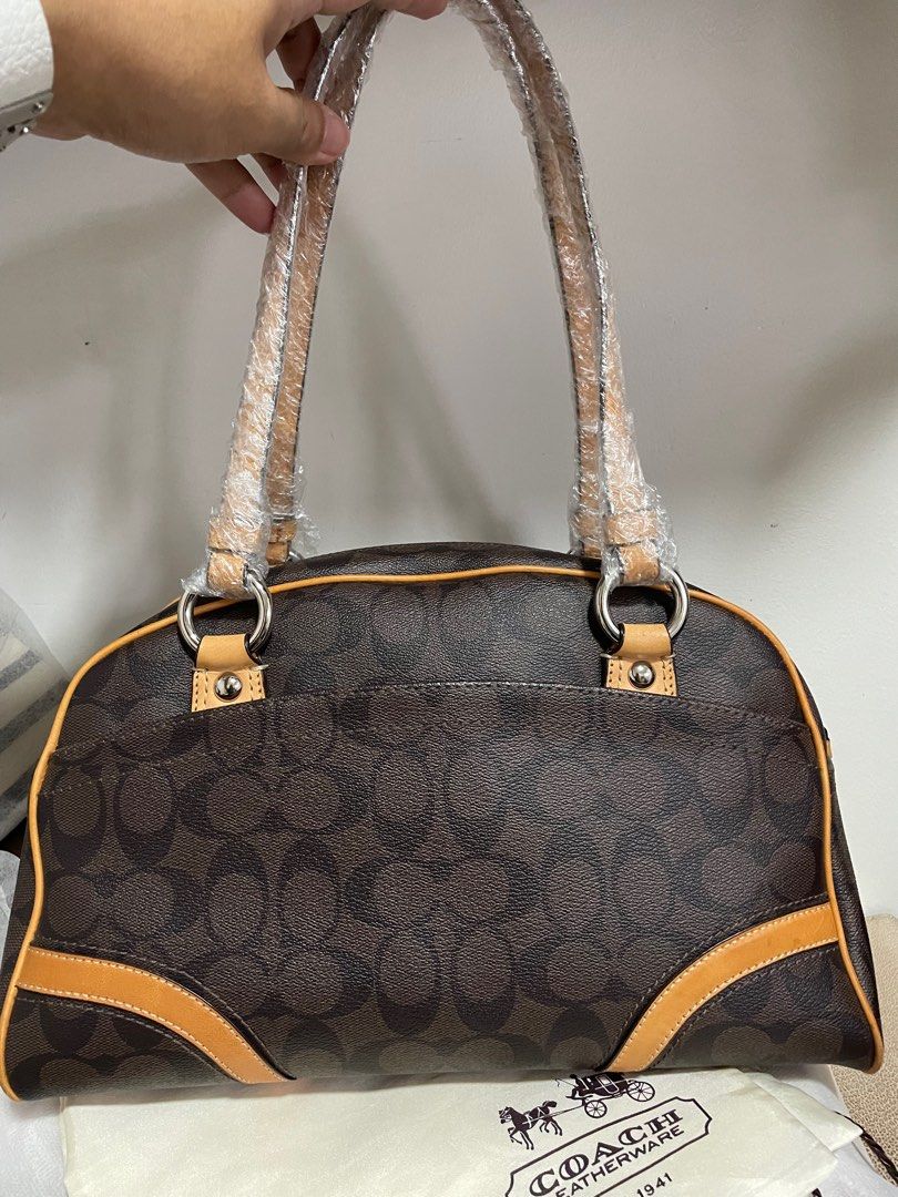 Authentic Coach Signature Heritage Boston (Category: Luxury Bags & Wallets) located in Guiguinto. Submitted by prelovedinc2024 (Listing ID 1389852832, Image 3). Description: guaranteed authentic, bought in Japan with signs of use - discoloration/oxidation on some parts, rubs/dirt on corners, some scratches on silver hardwares no cracks comes with dustbag size: 12x8x6”.