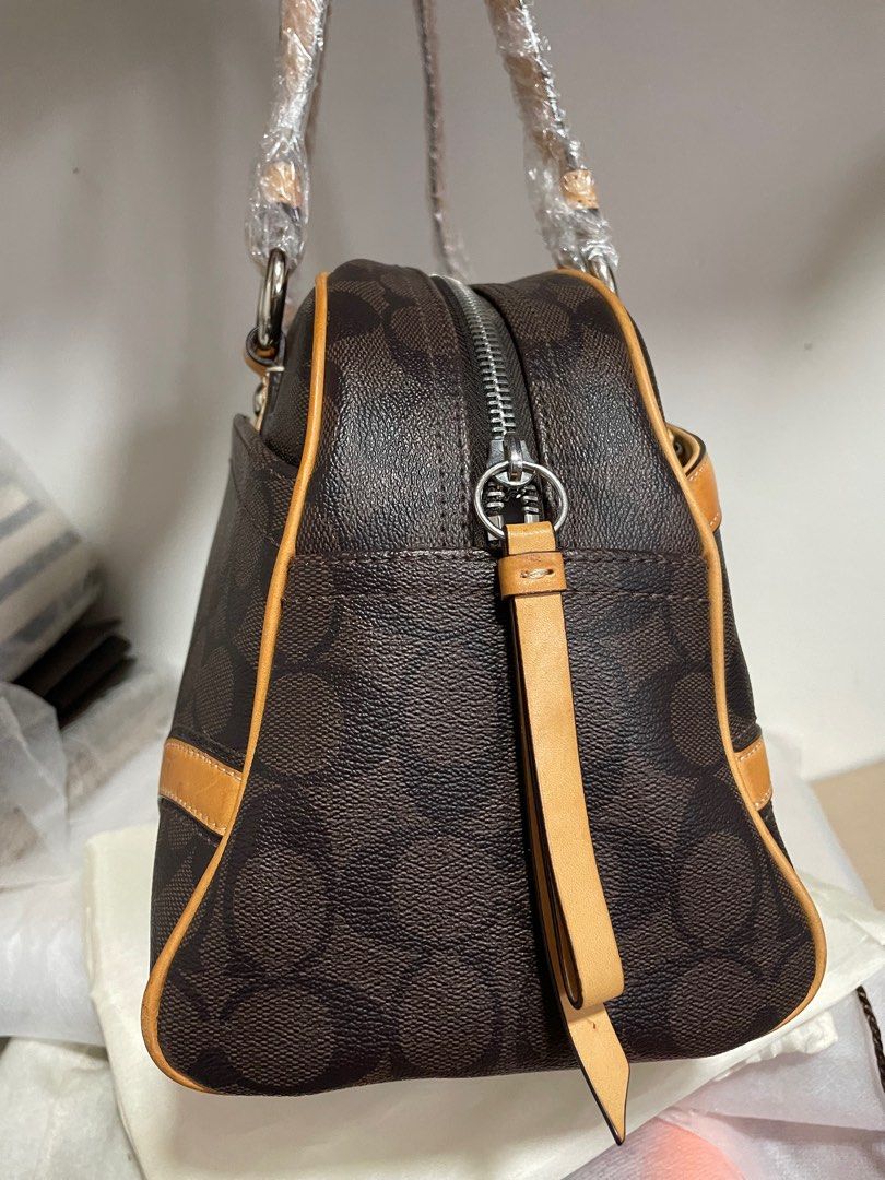 Authentic Coach Signature Heritage Boston (Category: Luxury Bags & Wallets) located in Guiguinto. Submitted by prelovedinc2024 (Listing ID 1389852832, Image 2). Description: guaranteed authentic, bought in Japan with signs of use - discoloration/oxidation on some parts, rubs/dirt on corners, some scratches on silver hardwares no cracks comes with dustbag size: 12x8x6”.