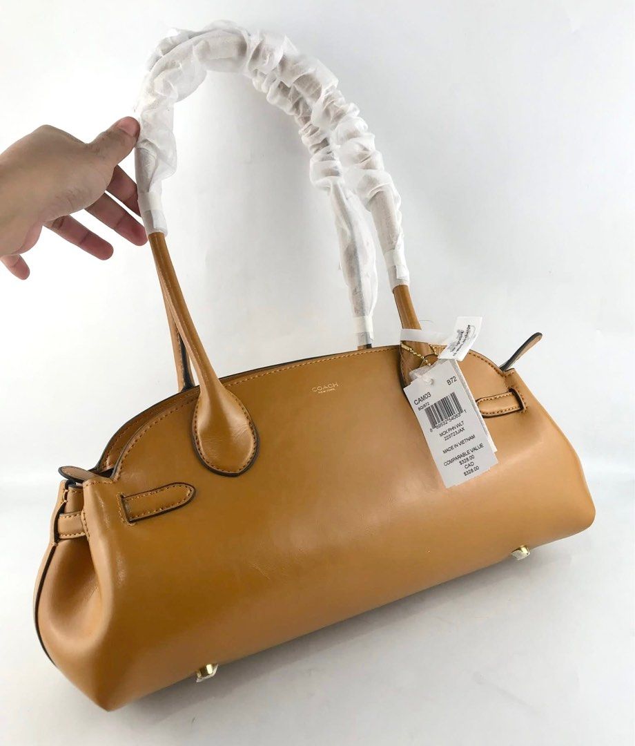 Coach Empire Carryall Hori Bag (Category: Shoulder Bags) located in Marikina City. Submitted by smthxtra (Listing ID 1390022449, Image 1). Description: Size: •Length: 13.5" •Height: 6.25" •Width: 4.75" Made in Cambodia - MPO Inside lanyard with dogleash clip Zip-top closure Four protective feet at base .