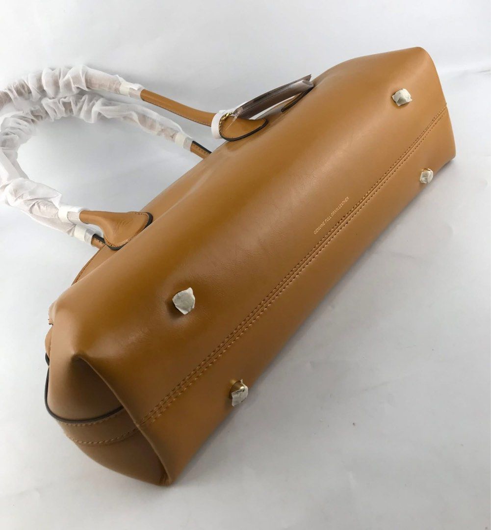 Coach Empire Carryall Hori Bag (Category: Shoulder Bags) located in Marikina City. Submitted by smthxtra (Listing ID 1390022449, Image 3). Description: Size: •Length: 13.5" •Height: 6.25" •Width: 4.75" Made in Cambodia - MPO Inside lanyard with dogleash clip Zip-top closure Four protective feet at base .