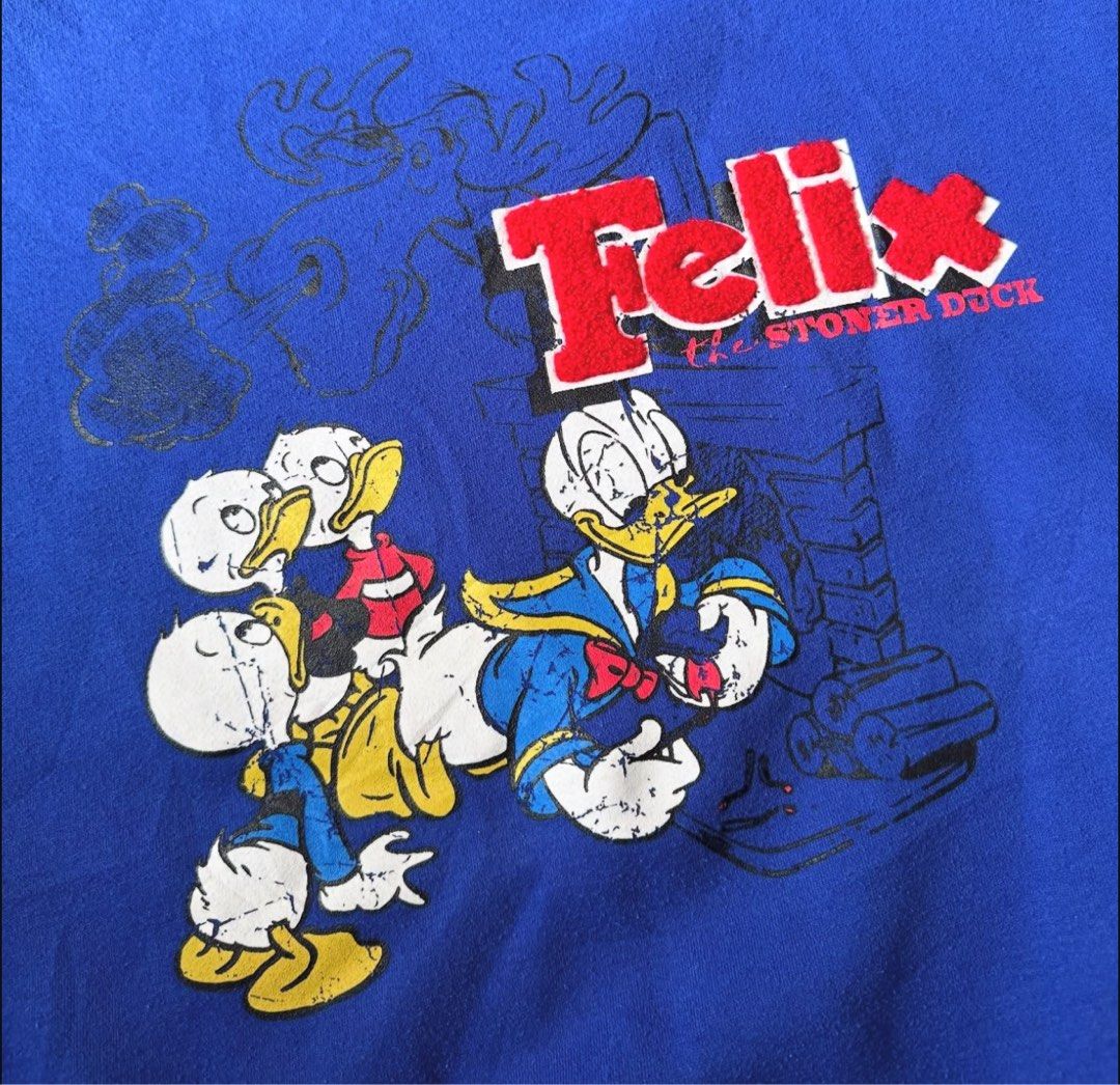 Donald duck boxy sweater (Category: Coats, Jackets and Outerwear) located in Binan City. Submitted by luckythriffs (Listing ID 1389856750, Image 2). Description: Felix Carpet Sweater Condition: 9.5/10 Issues: minor stain ~Dimes~ Fits M - L Length: 25” Width: 25” .