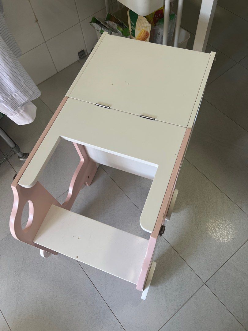 Foldable Learning Tower (Category: Other Kids Furniture) located in Singapore. Submitted by caterpiyarn (Listing ID 1389867327, Image 3). Description: Wooden learning tower that can be folded into kids desk. White and pink You can arrange your delivery or self collection .