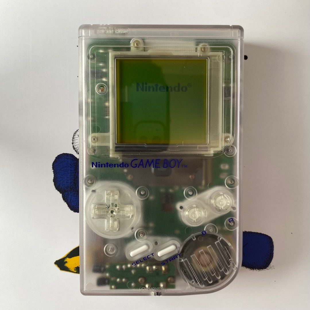 Game Boy (DMG) (Category: Nintendo) located in Pasig City. Submitted by mark_cedrick (Listing ID 1389875412, Image 2). Description: Classic original Game Boy (DMG model), fully functional and reshelled in a clear case. Features a glass screen lens for a cleaner look and better durability. 🎮 Fully working 🛠️ Reshelled in clear shell 🔍 Upgraded glass screen lens 📸 See photos for condition .