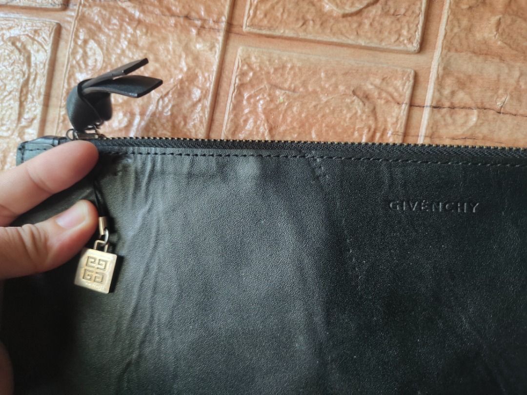 Givenchy Novelty Clutch/Pouch (Category: Luxury Bags & Wallets) located in Legazpi City. Submitted by roxy420 (Listing ID 1389850053, Image 2). Description: Smooth Working zipper With few dents on the leather due to storage Authentic Givenchy Novelty Gifts Coded.