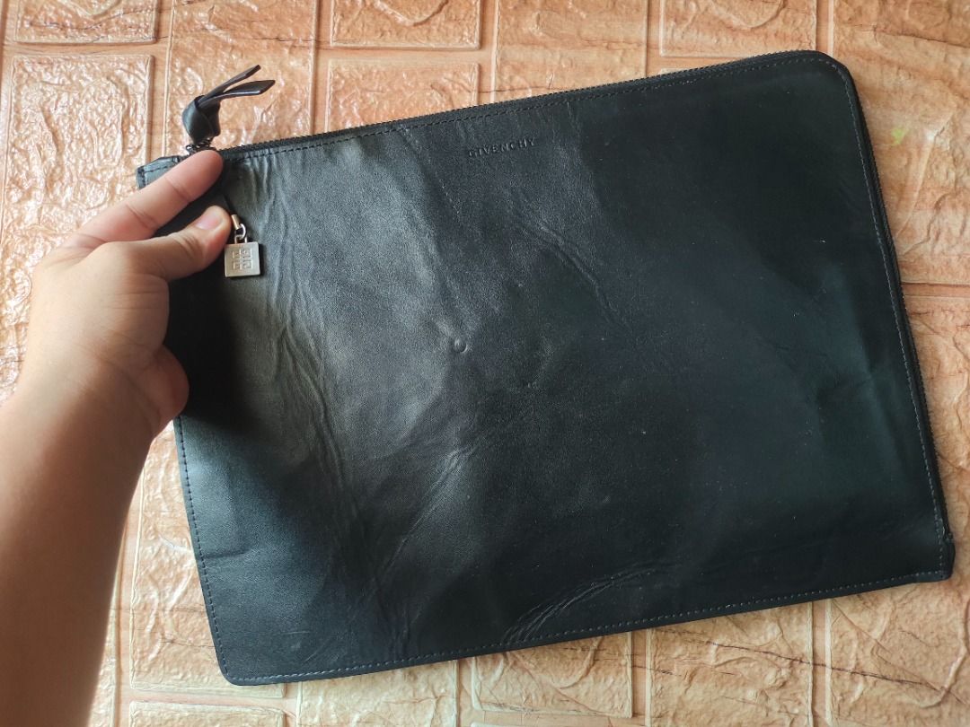 Givenchy Novelty Clutch/Pouch (Category: Luxury Bags & Wallets) located in Legazpi City. Submitted by roxy420 (Listing ID 1389850053, Image 1). Description: Smooth Working zipper With few dents on the leather due to storage Authentic Givenchy Novelty Gifts Coded.