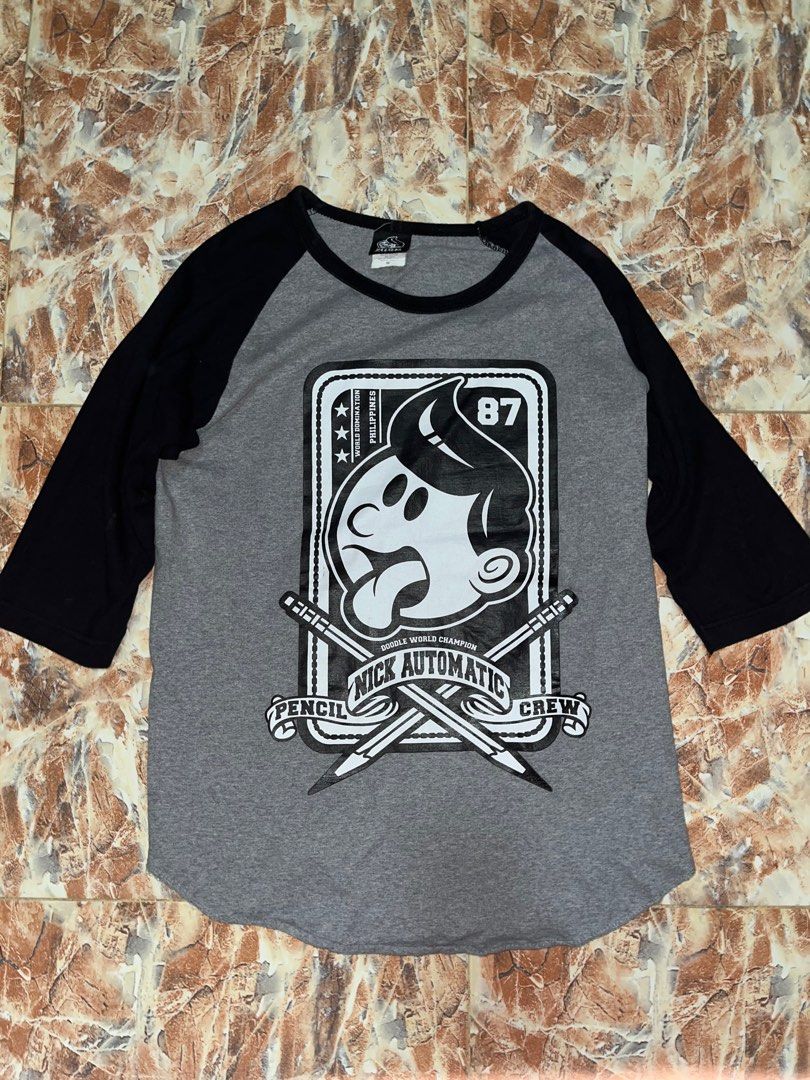 Nick Automatic Raglan Graphic Shirt (Category: Tshirts & Polo Shirts ) located in San Luis. Submitted by haggle.apparel (Listing ID 1389931505, Image 1). Description: Nick Automatic Raglan Graphic Shirt (Legit) Measurements: W-18 / L- 25 Condition: Used but not noticeable. No issues DM to inquire (NEGOTIABLE).