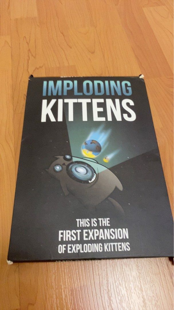 Imploding Kittens Expansion Pack for Exploding Kittens (Category: Board Games & Puzzles) located in Singapore. Submitted by lynramosp (Listing ID 1384773808, Image 1). Description: - Imploding Kittens expansion pack for Exploding Kittens. - Includes 20 new cards illustrated by The Oatmeal. - Adds support for a 6th player. - Features a human-sized Cone of Shame turn indicator. - Suitable for ages 7+..