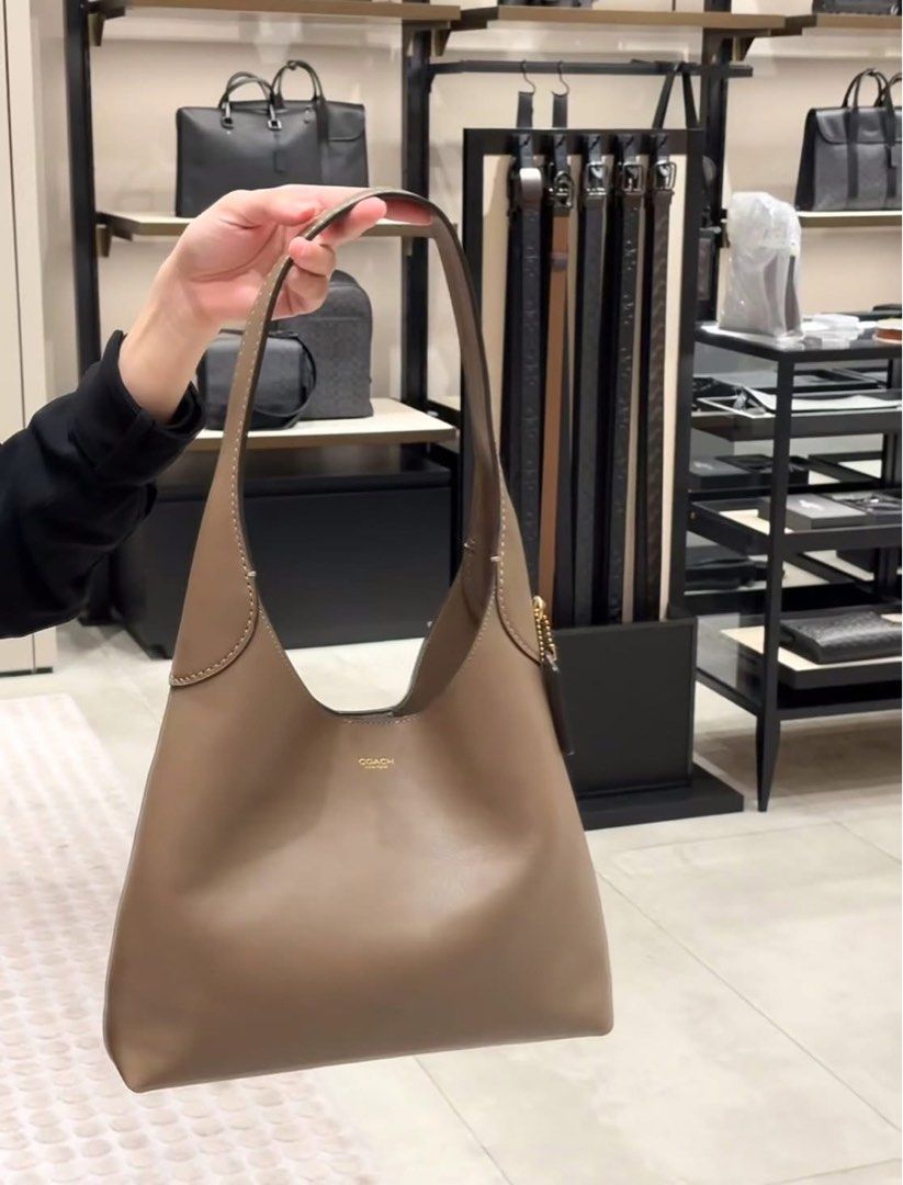 💯ORIGINAL COACH BROOKLYN 28 DARK STONE (Category: Luxury Bags & Wallets) located in Quezon City. Submitted by ashongsstore (Listing ID 1384785355, Image 1). Description: ✨NEW ARRIVALS✨ 🇵🇭AVAILABLE🇵🇭 BROOKLYN SHOULDER BAG 28 DARK STONE Ready to Ship PM us to order 💕 Our Brooklyn is an elegant, minimalist silhouette—with a distinctly New York attitude. Smaller than the 39, the hobo style is crafted of natural grain leather with beautiful text