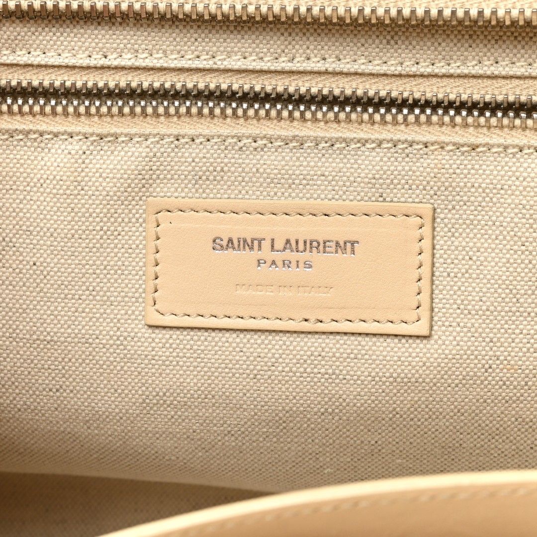YSL RAFFIA SMALL RIVE GAUCHE CABAS NATURALE (Category: Luxury Bags & Wallets) located in Iloilo. Submitted by primefinds (Listing ID 1384692858, Image 3). Description: This is an authentic SAINT LAURENT Raffia Small Rive Gauche Cabas in Naturale. This handbag is crafted of woven straw in beige with leather accents. The bag features woven top handles and a removable, adjustable leather shoulder strap. The top zipper opens to a matching fabric inte