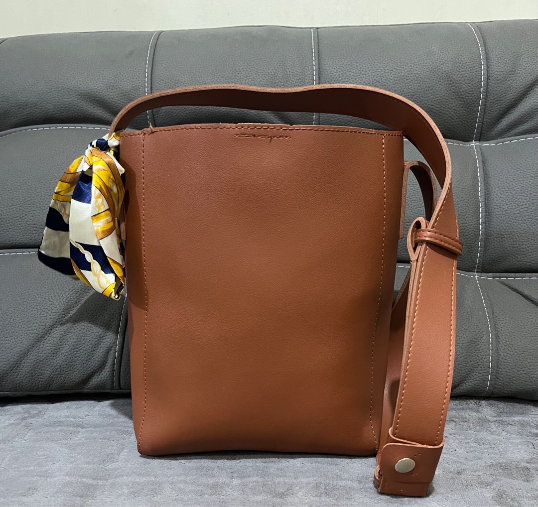 bucket type with snap button lock sling bag, Women's Fashion, Bags ...