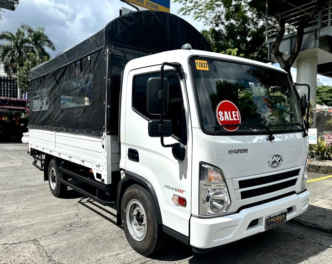 HYUNDAI HD45 GT 4W (Category: Heavy Vehicles) located in Pasig City. Submitted by tycoon.cars (Listing ID 1384910103, Image 1). Description: HYUNDAI HD45 GT 4W - 2022 Model - 3,XXX Original Mileage - 14-footer Dropside - Creamy White - Manual Transmission - 2.8L Diesel Engine - SUPER FRESH - RARE UNIT We Don’t Sell Cars, We Sell Dreams. BUY•SELL•TRADE•CONSIGN•FINANCING Tycoon Powercars www.tycoonpowercars.com Autocamp #100 Ortigas Avenue, Pasig C