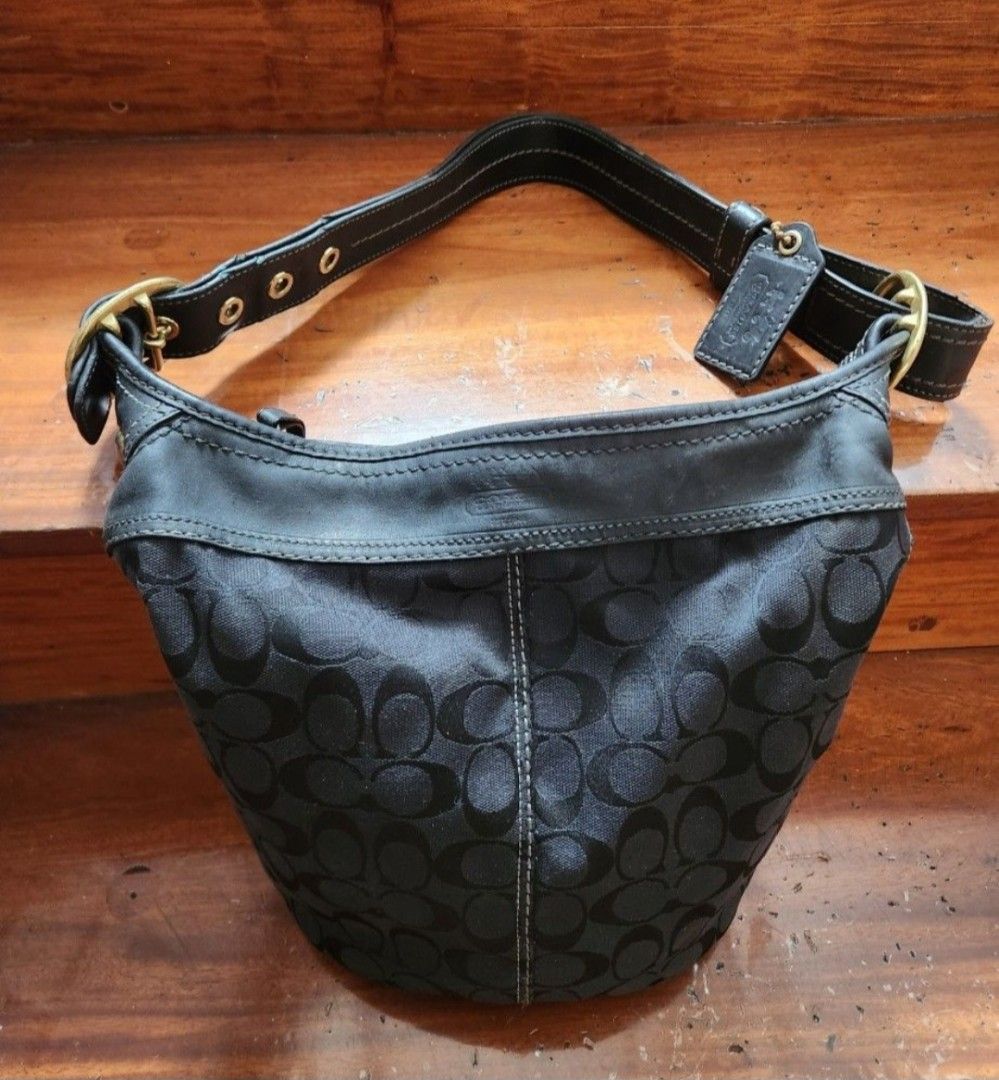 Coach Bleeker bag (Category: Luxury Bags & Wallets) located in Caloocan City. Submitted by geminimomma2 (Listing ID 1385055489, Image 1). Description: This is a medium-sized bucket/duffel bag w/ the monogram C pattern. Good for daily use. Fabric: Jacquard Finish: Matte Enclosure: Zip Incl: Bag charm; thick adjustable strap Dimensions : H-10in w/o strap, W-11in Serial: J076811487 Issue: Minor discoloration on leather Price is negotiable..