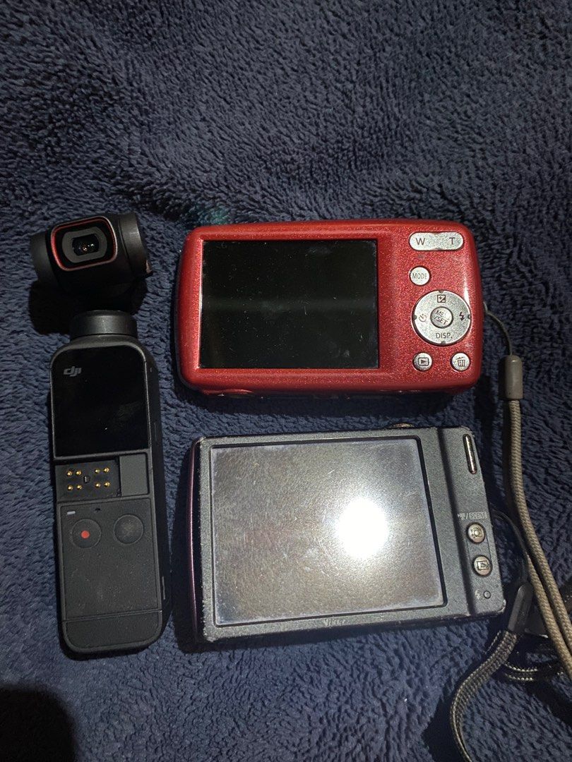DIGICAMS FOR SALE (Category: Cameras) located in Manila. Submitted by spotless.mins (Listing ID 1385173802, Image 2). Description: Take all for 2k! (Negotiable) DJI Osmo Pocket 2. (500) Issue: Gimbal not working. Needs to be plugged in to power on. For repair Lumix Camera (550) Fully working. With Battery and Charger Issue: SD card slot has a problem — can’t read SD cards. Nikon Coolpix (550) Still functional. With Batter Issues: Screen burn, and