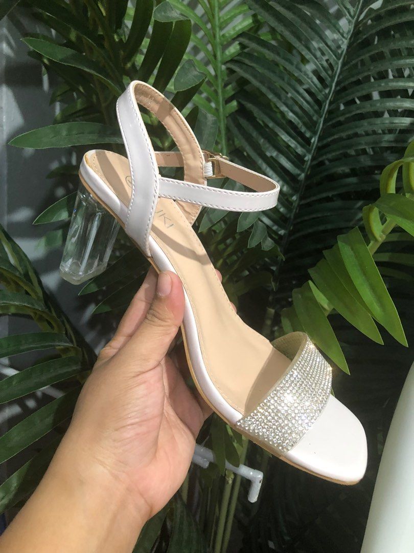 SUKI Rhinestone Clear Heeled Ankle Strap Sandals (Category: Heels) located in Caloocan City. Submitted by annacruzita (Listing ID 1385179391, Image 1). Description: Used as Bridal Shoes Size 38 Heel Height: 2 inches Rfs: Decluttering.