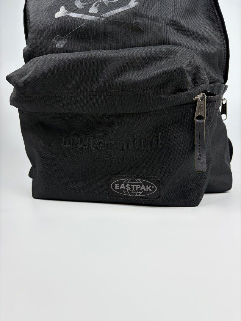 Mastermind x Eastpak Backpack (Category: Backpacks) located in Manila. Submitted by sc_rcity (Listing ID 1385426082, Image 3). Description: Technical canvas backpack in black. Tonal webbing carry handle at top. Twin adjustable padded shoulder straps. Tonal bonded logo, tonal embroidered logo, tonal textile logo patch, and zippered pocket at face. Zippered pocket at side. Tonal textile logo patch at back face. Two-way zip closure at main compartme