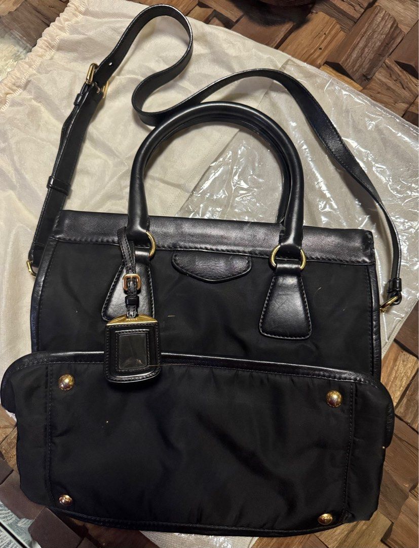 (Neg) Prada Nylon Leather Two Way Tote Bag (Category: Luxury Bags & Wallets) located in Quezon City. Submitted by sun.eri (Listing ID 1385363875, Image 3). Description: Preloved Authentic Prada Two-Way Tote Bag (Hand bag and crossbody bag) Still in very good condition and functional Flaw: Crack on one handle but the crossbosy strap is in excellent condition (see photo). ✔️ Comes with dust bag only 💬 Feel free to message for more details 👀 Pleas