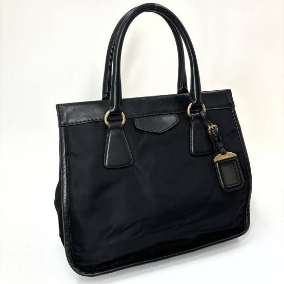 (Neg) Prada Nylon Leather Two Way Tote Bag (Category: Luxury Bags & Wallets) located in Quezon City. Submitted by sun.eri (Listing ID 1385363875, Image 1). Description: Preloved Authentic Prada Two-Way Tote Bag (Hand bag and crossbody bag) Still in very good condition and functional Flaw: Crack on one handle but the crossbosy strap is in excellent condition (see photo). ✔️ Comes with dust bag only 💬 Feel free to message for more details 👀 Pleas
