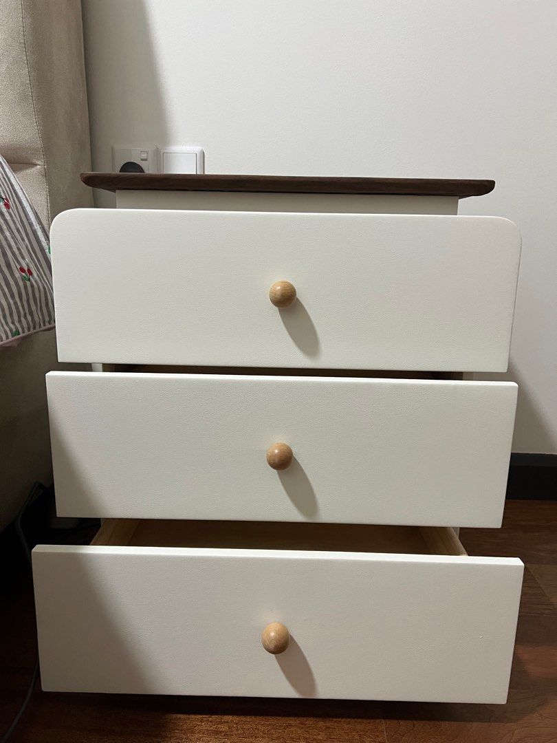 Bedside table (Category: Shelves, Cabinets & Racks) located in Kuala Lumpur. Submitted by mabkittie (Listing ID 1385593230, Image 1). Description: Bedside table - 3 drawers White colour with wooden top Size 50x40x58 cm Brand new with very small dent at the side I have 2 units for sale (price stated is for 1 unit).