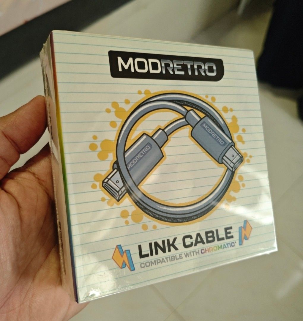 ModRetro Link Cable (Category: Cables & Chargers) located in Singapore. Submitted by radin76 (Listing ID 1385606613, Image 1). Description: Battle it out, side by side. The ModRetro Link Cable connects two Chromatics for multiplayer gameplay on supported titles. Just power on, plug in, and let the head-to-head action begin. 6.5 feet long. Features Enables multiplayer gameplay between two Chromatics Long 6.5-foot cable lets you play with maximum f