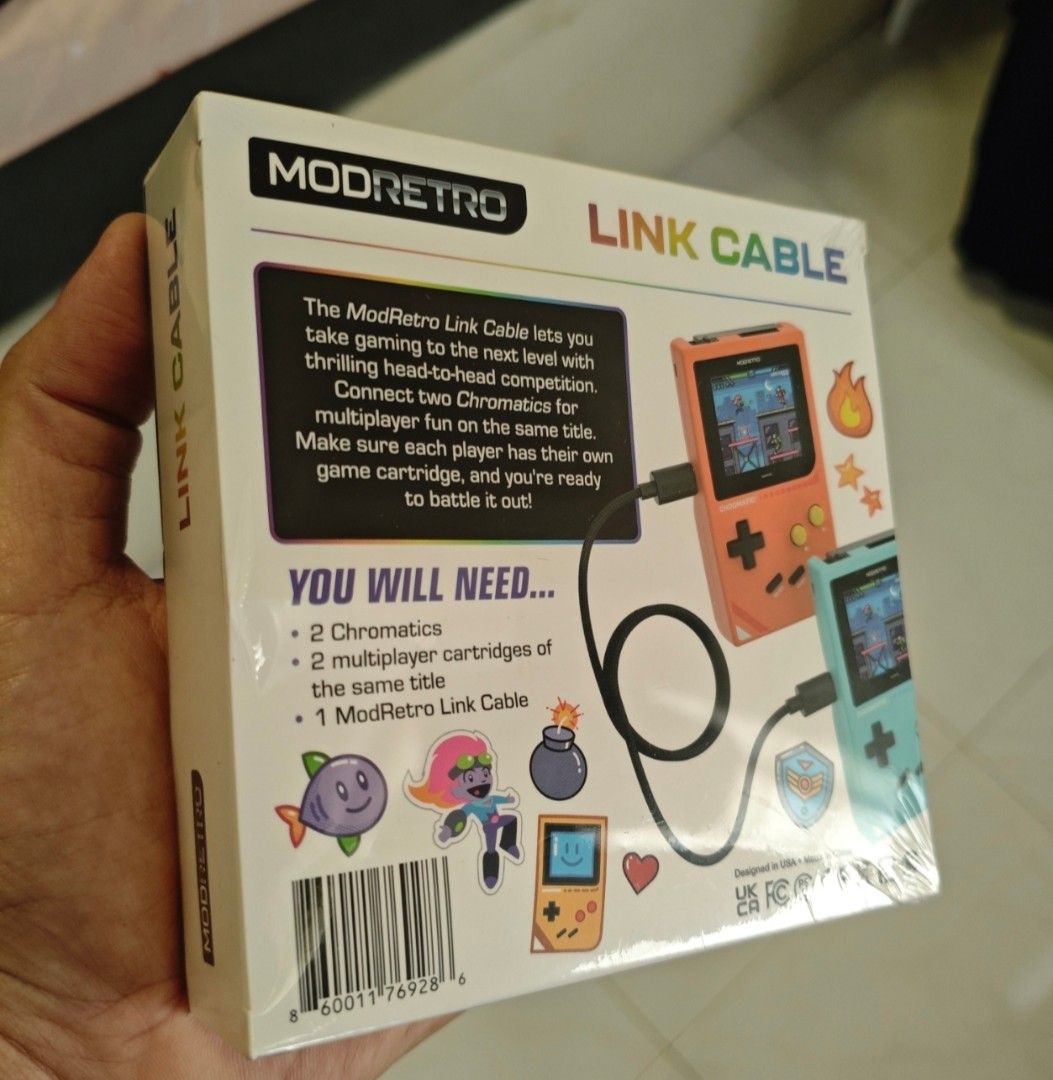 ModRetro Link Cable (Category: Cables & Chargers) located in Singapore. Submitted by radin76 (Listing ID 1385606613, Image 2). Description: Battle it out, side by side. The ModRetro Link Cable connects two Chromatics for multiplayer gameplay on supported titles. Just power on, plug in, and let the head-to-head action begin. 6.5 feet long. Features Enables multiplayer gameplay between two Chromatics Long 6.5-foot cable lets you play with maximum f