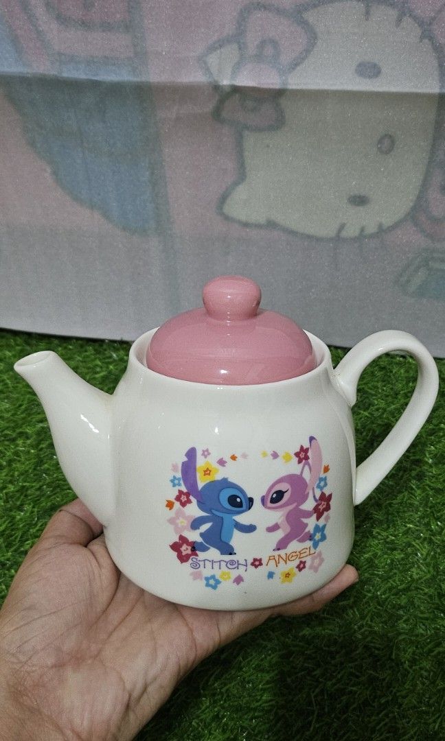 Stitch & angel ceramic tea pot (Category: Coffee & Tea Tableware) located in Umingan. Submitted by liezelsona48963 (Listing ID 1385450791, Image 1). Description: disney ceramics tea pot 4 inches mop gcash.