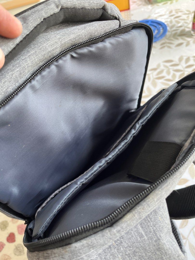 Grey Backpack - Multiple Compartments (Category: Backpacks) located in Singapore. Submitted by coolphoenix.1836a4 (Listing ID 1385646460, Image 5). Description: - Stylish grey backpack - Multiple compartments for organized storage - Includes a key holder - Comfortable padded straps - Perfect for everyday use and travel - Excellent condition.
