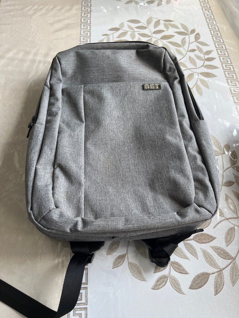 Grey Backpack - Multiple Compartments (Category: Backpacks) located in Singapore. Submitted by coolphoenix.1836a4 (Listing ID 1385646460, Image 4). Description: - Stylish grey backpack - Multiple compartments for organized storage - Includes a key holder - Comfortable padded straps - Perfect for everyday use and travel - Excellent condition.