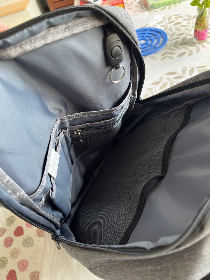 Grey Backpack - Multiple Compartments (Category: Backpacks) located in Singapore. Submitted by coolphoenix.1836a4 (Listing ID 1385646460, Image 1). Description: - Stylish grey backpack - Multiple compartments for organized storage - Includes a key holder - Comfortable padded straps - Perfect for everyday use and travel - Excellent condition.