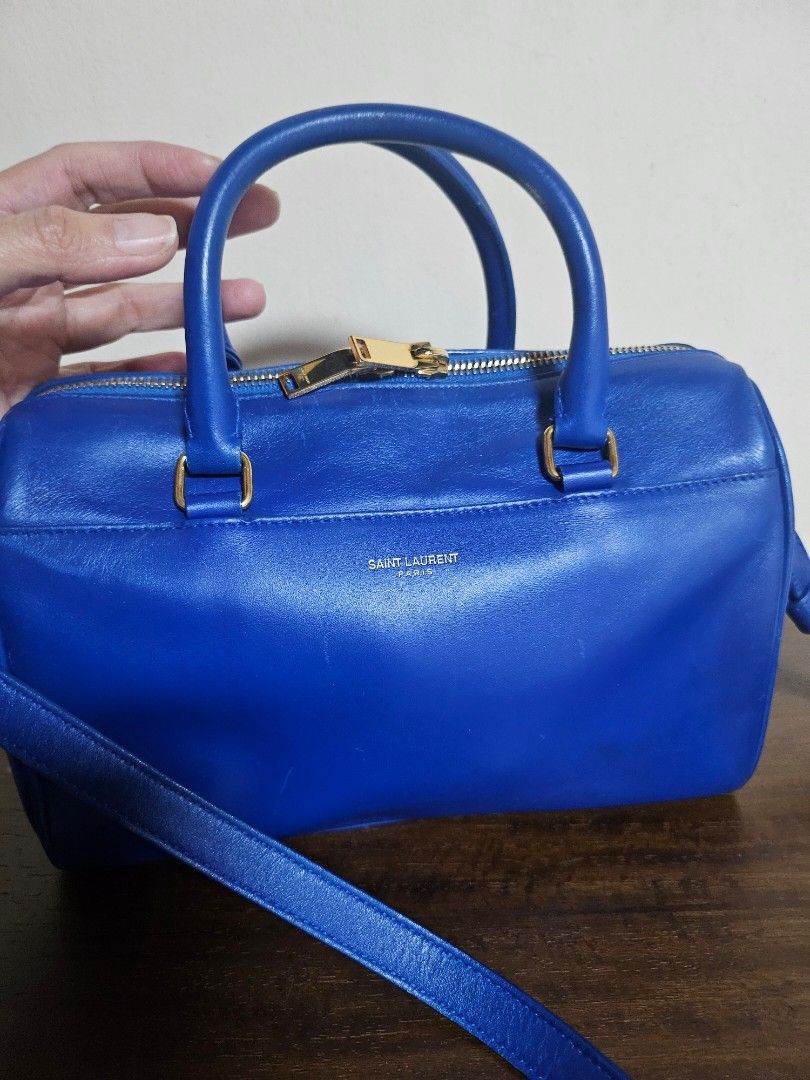 Mark Down! Authentic Saint Laurent Sac de Jour Nano Duffle (Category: Luxury Bags & Wallets) located in Las Pinas. Submitted by GGsCloset (Listing ID 1390163920, Image 1). Description: Authentic. Bag only. Saint Laurent Nano Duffle Bag in Electric Blue with gold hardware. Length: 9.4 in (24 cm) Height: 6.2 in (16 cm) Depth: 4.7 in (12 cm) Handle Drop: ~3 in (8 cm) Strap Drop: ~22 in (56 cm), adjustable/detachable.