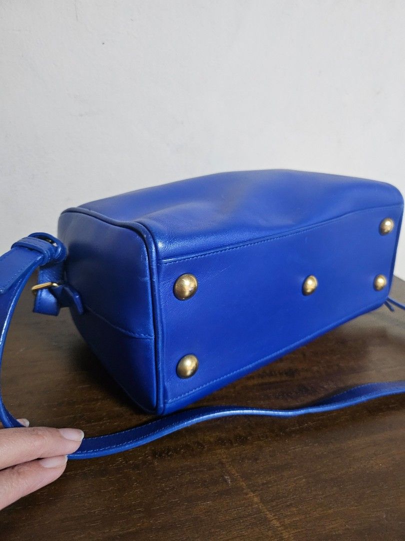 Mark Down! Authentic Saint Laurent Sac de Jour Nano Duffle (Category: Luxury Bags & Wallets) located in Las Pinas. Submitted by GGsCloset (Listing ID 1390163920, Image 2). Description: Authentic. Bag only. Saint Laurent Nano Duffle Bag in Electric Blue with gold hardware. Length: 9.4 in (24 cm) Height: 6.2 in (16 cm) Depth: 4.7 in (12 cm) Handle Drop: ~3 in (8 cm) Strap Drop: ~22 in (56 cm), adjustable/detachable.