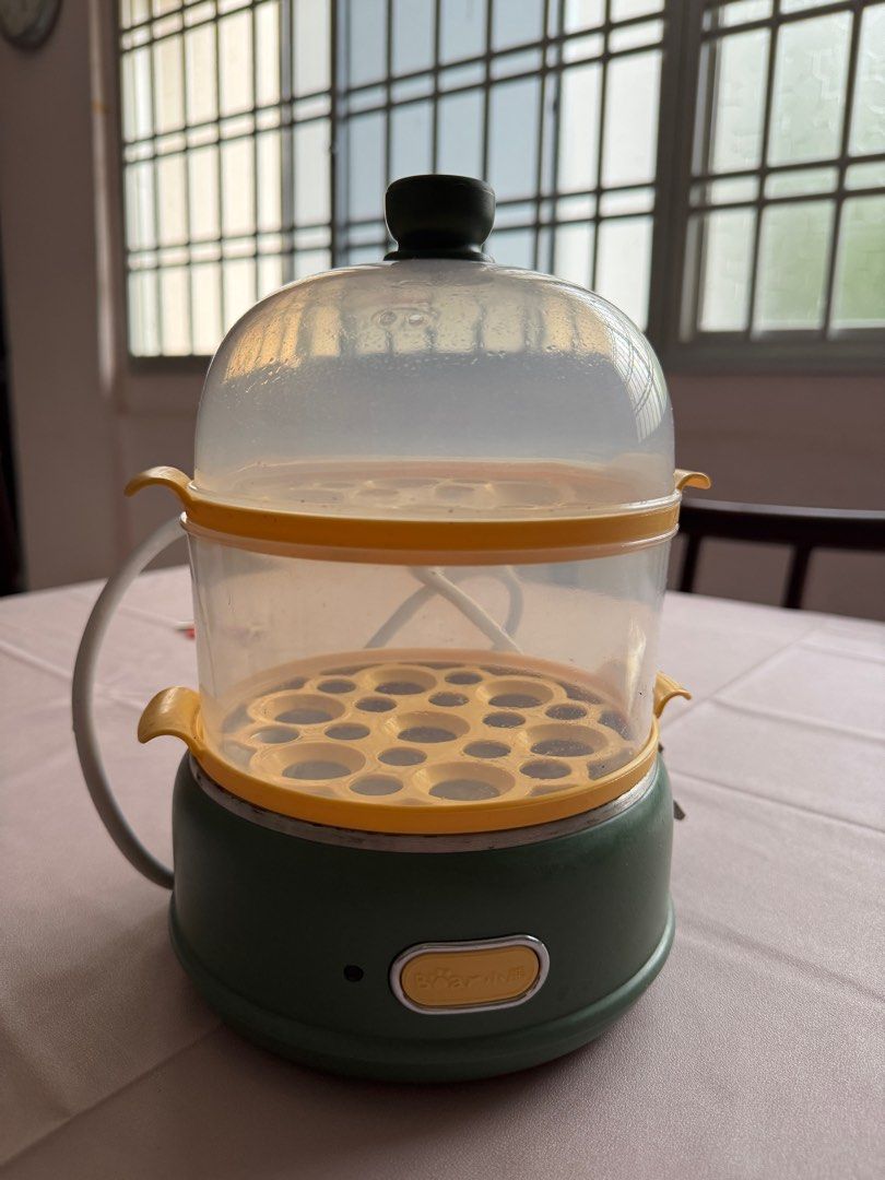Bear Egg Steamer (Category: Cookware & Accessories) located in Singapore. Submitted by evel9777 (Listing ID 1390042821, Image 1). Description: - Used Bear egg steamer - Green base with yellow accents - Transparent lid included - Comes with two steaming trays - Cooks eggs quickly and easily - In good working condition.