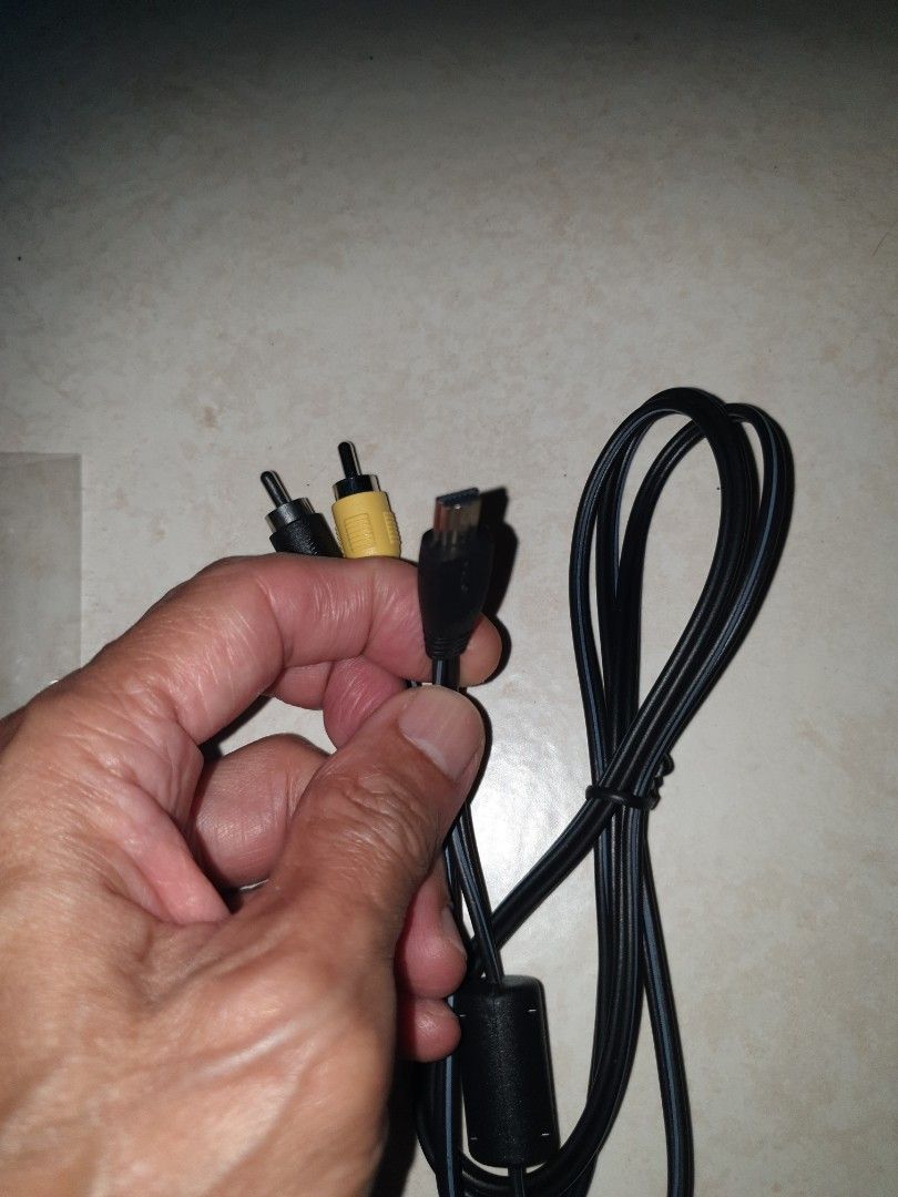 Camera audio cable (Category: Cables & Adaptors) located in Singapore. Submitted by sengkang-ranggung (Listing ID 1390049698, Image 1). Description: The cable has a mini-USB connector on one end and yellow/black RCA connectors on the other. Free mailing possible. No refund after buying for whatever reason. $8.80 nett. pick up Ranggung lrt, Sengkang mrt..