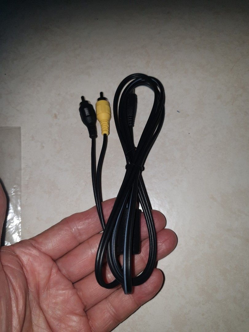 Camera audio cable (Category: Cables & Adaptors) located in Singapore. Submitted by sengkang-ranggung (Listing ID 1390049698, Image 3). Description: The cable has a mini-USB connector on one end and yellow/black RCA connectors on the other. Free mailing possible. No refund after buying for whatever reason. $8.80 nett. pick up Ranggung lrt, Sengkang mrt..