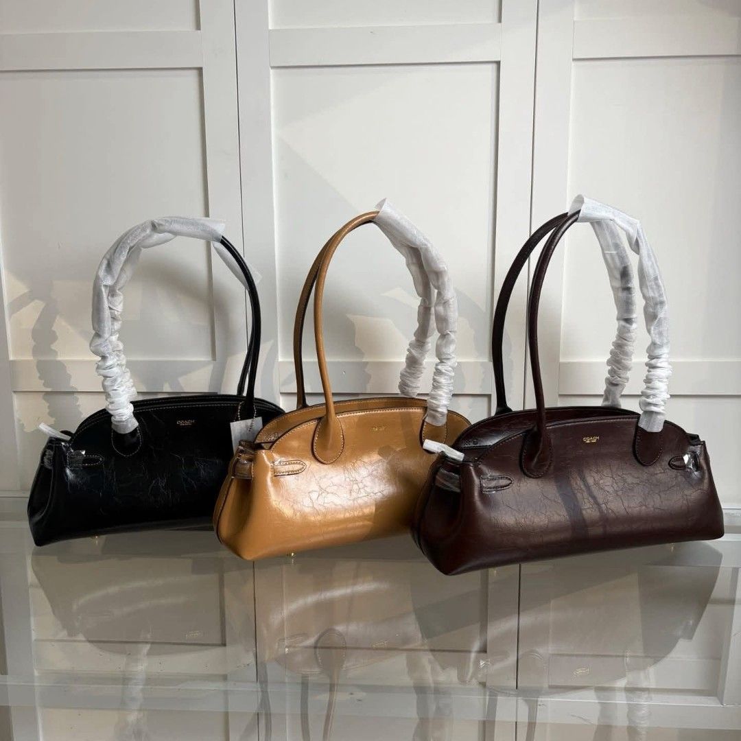 Coach Empire Carryall Bag 34 (Category: Shoulder Bags) located in Manila. Submitted by stacey_lopez922 (Listing ID 1390152803, Image 1). Description: Coach Empire Carryall Bag 34 (With dustbag and paperbag) - 13.5"L x 6.25"H x 4.75"W - Glazed leather - Fabric lining - Inside lanyard with dogleash clip - Inside multifunction pocket - Zip-top closure - Four protective feet at base.