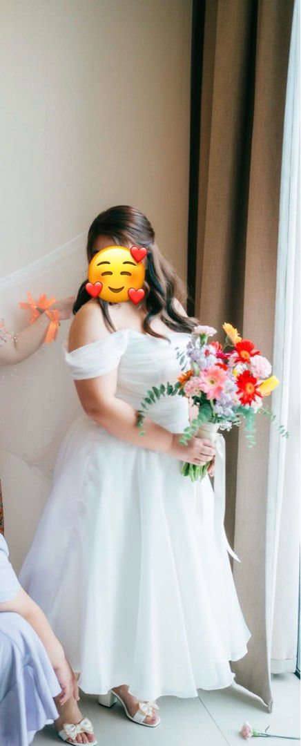 Minimalist bridal dress (Category: Evening dresses & gowns) located in Naic. Submitted by joancust (Listing ID 1390111436, Image 3). Description: PHello future brides 👰‍♀️ I am selling my civil wedding dress used last June 2025. Plus size, ivory color, tea length (my height is 5'2"), combination of jusi skirt and top tulle 💕 RFS: storage Price: 9k (originally bought it for 12k) Location: Cavite Will also include the beaded veil 🙂 Thank you po 
