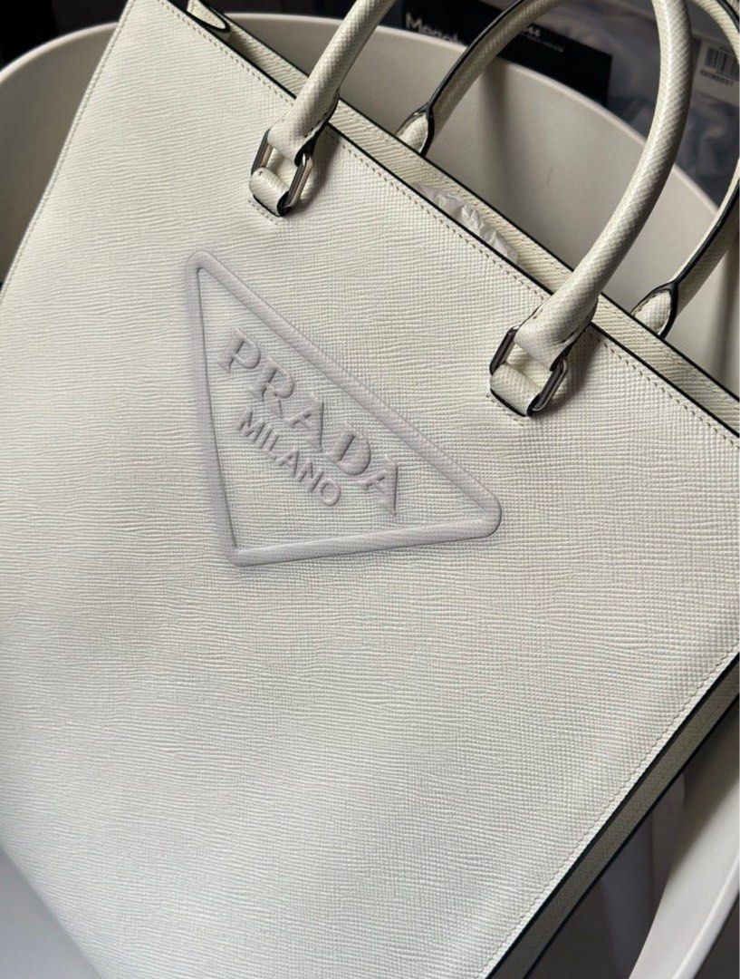 Prada Embossed Logo White Saffiano Tote Bag (Category: Cross-body Bags) located in Taguig. Submitted by jthnl (Listing ID 1390124535, Image 1). Description: Dimensions: Length: 14.25 in Height: 14.25 in Width: 3.5 in.