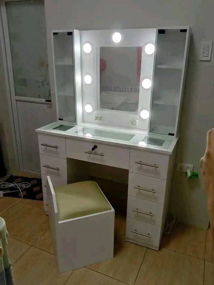 VANITY DRESSER WITH BULB (Category: Shelves, Cabinets & Racks) located in Mabalacat. Submitted by arlenemamangun01 (Listing ID 1390089186, Image 1). Description: "Get ready to glow! 💄💅 Made-to-order Makeup Table/Vanity Dresser with Mirror Plyboard vinyl laminated, with lights and chair Glass table or wood table options available 100% quality guaranteed! 💯 Best seller alert! 🔥 Message us to order now! 📲".