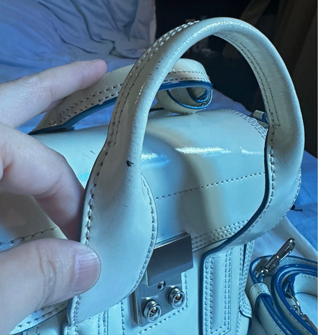 3.1 Philip Lim Mini Pashli (Category: Luxury Bags & Wallets) located in Quezon City. Submitted by tiffngo_cheng (Listing ID 1391816135, Image 3). Description: SALE!!!! Mini Pashli in White with Blue trims With dustbag Has minimal flaws The iconic 3.1 Phillip Lim bag, the Pashli Mini Satchel is made from smooth leather and crafted to a compact shape. Its structured silhouette features expandable side zip pleats and its flap front closure secures w