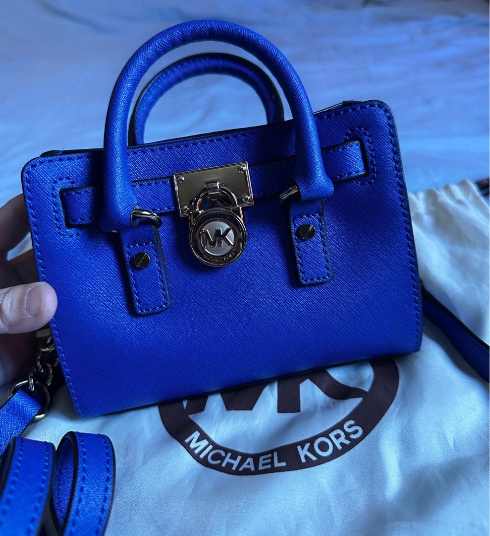 Michael Kors Micro Hamilton Bag (Category: Luxury Bags & Wallets) located in Quezon City. Submitted by tiffngo_cheng (Listing ID 1391809713, Image 3). Description: Never used - bought & kept Color - Royal Blue With dust bag This bag is part of the iconic Hamilton collection by Michael Kors. It features a belted silhouette with a polished padlock charm and gold-tone hardware. Crafted from high-quality leather, it offers both durability and a luxur