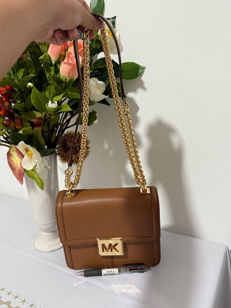 Michael Kors Sonia small shoulder/sling bag (Category: Cross-body Bags) located in San Fernando. Submitted by 3s_preloved (Listing ID 1391883427, Image 2). Description: ✅ My personal preloved from Canada ✅ with tag and care card ✅ Gold tone Hardware ✅ Can be use as shoulder bag or pwede rin sling ✅ Intact runner lining ✅ Kasya phone and smal wallet ✅ Good as new! Pwede pa panregalo. Bihira ko po to ginamit🥰 No issue! ❗️FREE SF❗️ Location🇸🇽: Sa