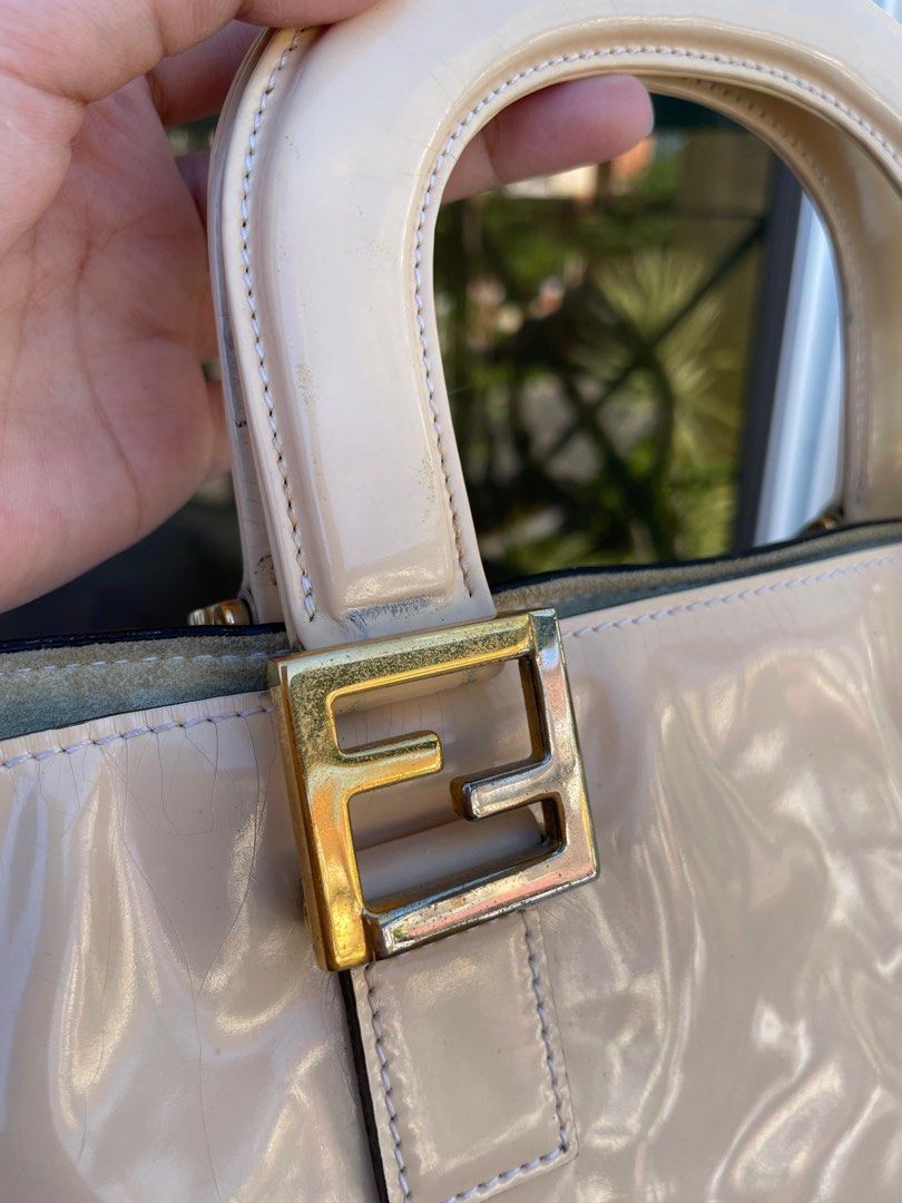 Fendi Patent Hand Bag 💯AUTHENTIC (Category: Luxury Bags & Wallets) located in Mandaluyong City. Submitted by vintageboxfinds (Listing ID 1392041237, Image 3). Description: There are noticeable signs of wear, such as scratches, scuffs, or discoloration, especially on the corners or hardware. Despite cosmetic flaws, the item is still functional and stylish, priced accordingly to reflect its condition. + SF (NO RETURN NO EXHANGE) .