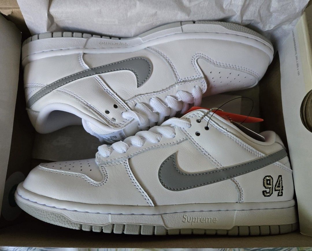Supreme x Nike SB Dunk Low (Category: Sneakers) located in Makati City. Submitted by olaxb (Listing ID 1392011060, Image 1). Description: - Supreme x Nike SB Dunk Low OG QS - White and grey colorway - Size 6.5 - Brand new, never worn - Comes with original box and tags.