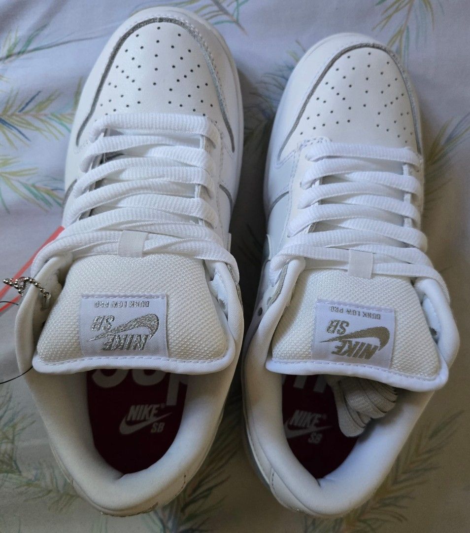 Supreme x Nike SB Dunk Low (Category: Sneakers) located in Makati City. Submitted by olaxb (Listing ID 1392011060, Image 2). Description: - Supreme x Nike SB Dunk Low OG QS - White and grey colorway - Size 6.5 - Brand new, never worn - Comes with original box and tags.