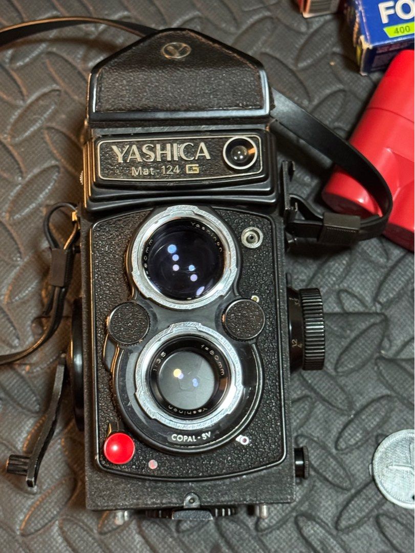 Yashica Mat 124G (Category: Cameras) located in Manila. Submitted by film.jiteiro (Listing ID 1392091543, Image 1). Description: Yashica Mat 124G - TLR Film Camera - Comes with a RARE eye level viewfinder/prism (removable if you want to switch to waist level) - Uses 120 film (6x6) - Fixed Yashinon 80mm (f/3.5-22) sharp lens - shutter speed (1-500) - Asa (25-400) - Signs of use on metal parts - Film tested - Inclusions: 3D printed lens cover + hoo