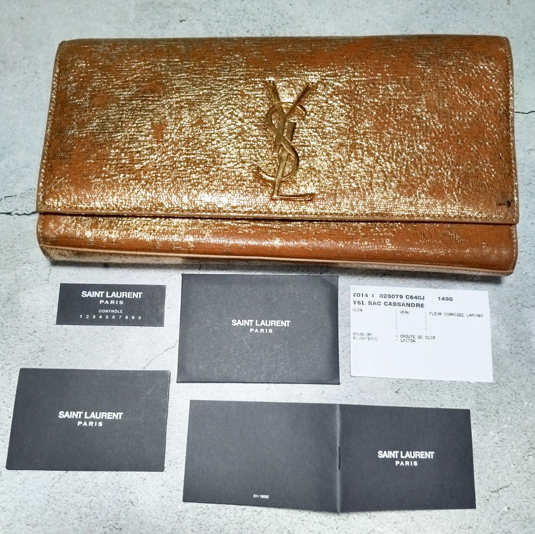 YSL Sac Cassandre Bag ✨ (Category: Luxury Bags & Wallets) located in Manila. Submitted by mnlhappybattle (Listing ID 1392087177, Image 1). Description: YSL Sac Cassandre Bag ✨ Authentic Saint Laurent Paris clutch in metallic gold. Condition: Minimal color issue as seen in photos, but still very presentable and stylish — the wear even adds unique character to the bag. Inclusions: With authenticity cards (no dust bag). Timeless piece that elevates 