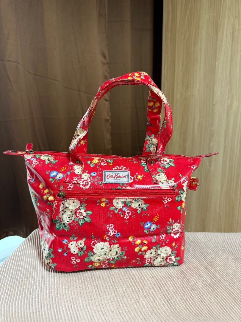 Cath Kidston Red Floral Tote Bag (Category: Tote Bags) located in Quezon City. Submitted by GreatFindsQC (Listing ID 1392276379, Image 2). Description: Authentic Cath Kidston Red Floral Tote Bag Iconic Vintage design Waterproof, PVC like material Can be used as hand or shoulder bag Well used and in very good condition No other inclusions .