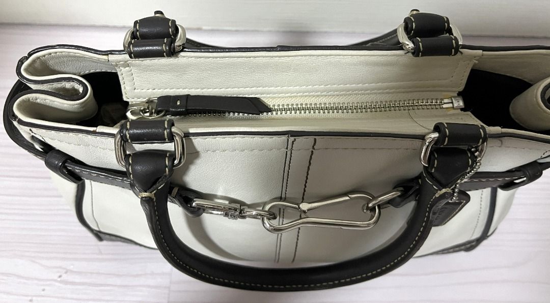 [Pre-Loved] Coach Leather Handbag Purse (Category: Luxury Bags & Wallets) located in Pasig City. Submitted by findingviolet (Listing ID 1392427438, Image 3). Description: [Pre-Loved] Coach Leather Handbag Purse - Original Style: Handbag / Purse Color: Ivory with dark brown accents Material: Leather Condition: Used with care - actual photos posted, some scratches on the silver buckle RFS: Decluttering Mode of Payment: GCash / Maya / BPI Bank Trans