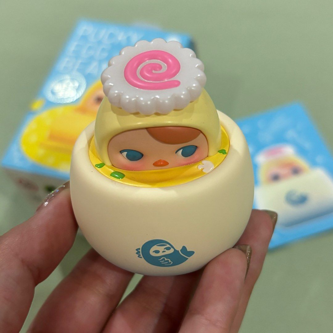 Pucky Egg Beanie Steamed Egg Mini Figurine (Category: Designer & Blind Box Toys) located in Antipolo. Submitted by de.klutter (Listing ID 1392422576, Image 2). Description: POPMART Pucky Egg Beanie Series Blindbox: Steamed Egg Mini Figure CONDITION: Brand new! Just bought recently from Fully Booked. Still comes with its original box, foil & card packaging Open to swap/trade with: Pucky Egg Tart, Nyota Poem, Nyota Feeling, Nyota Hidden in Autumn P
